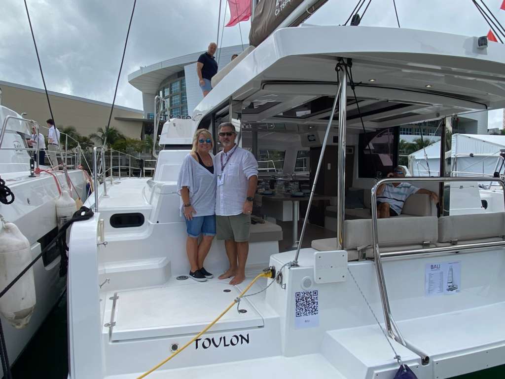 Bali Catspace catamaran bow sunbed lounging area with city skyline