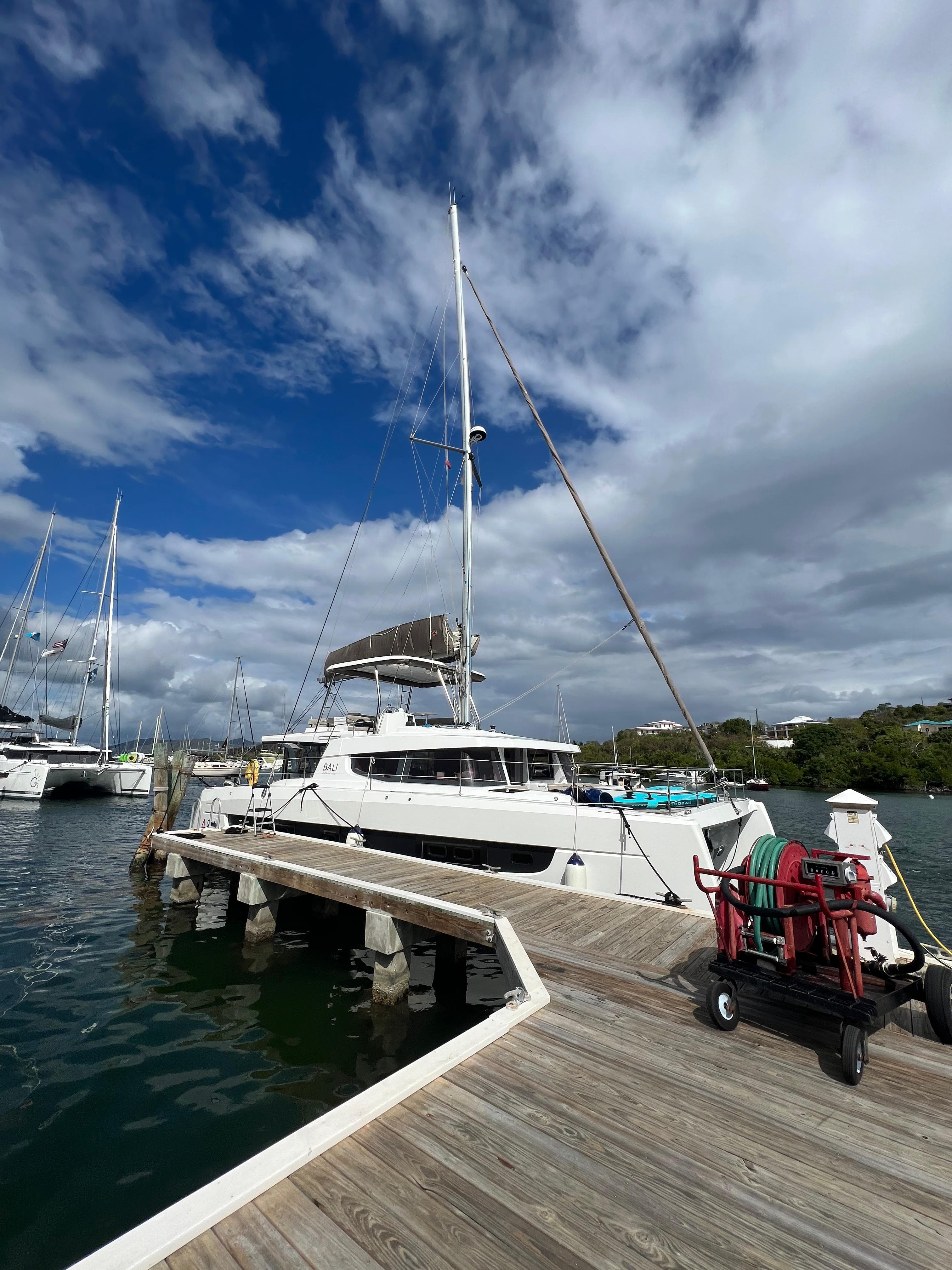 Bali Catspace catamaran docked at wooden pier marina