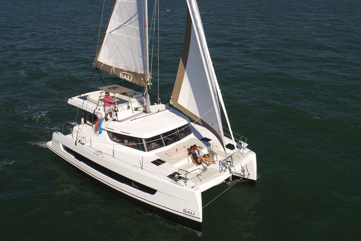 Bali Catspace catamaran aerial view with guests lounging on bow