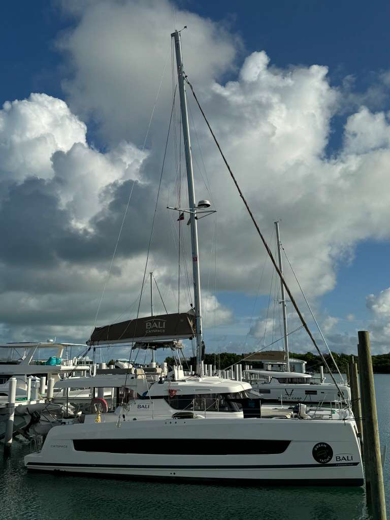 Bali Catspace docked at marina with dramatic clouds in sky