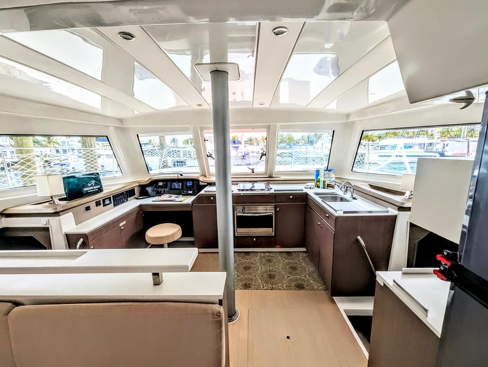 Open salon and galley with panoramic marina views